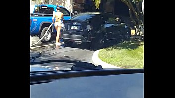 Sexy teen washing car in 2 piece bikini