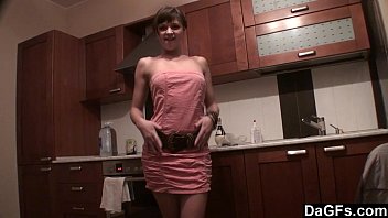 Freckled-face baby plays with her dildo on kitchen counter